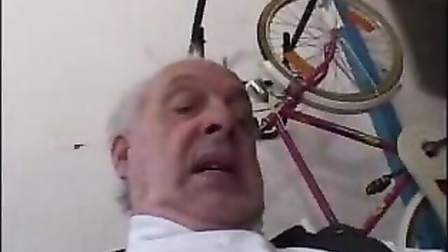 Old man grinning by bike in garage, teen porn preview