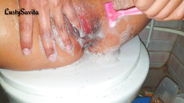 Indian teen LustySavita shaving wet pussy on toilet POV