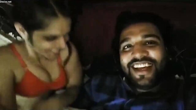 Indian wife in red bra teases smiling man in bed