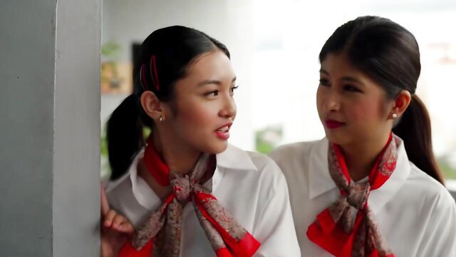 Two sexy Filipina flight attendants in red scarves whispering intimately, Vivamax Elevator Lady
