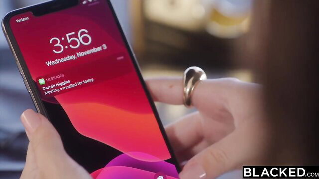 Liz Jordan checks phone with Blacked message on sexy iPhone screen