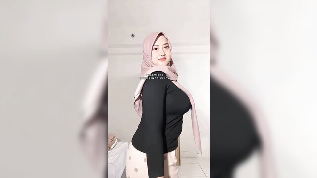 Indo hijab beauty in tight black top and pants, sexy side pose