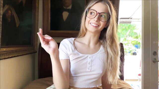 Skinny blonde stepsister in white crop top smiles playfully at camera