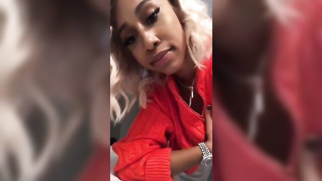 Closeup of sexy teen ebony babe with blonde hair in red jacket