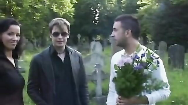 Angel Dark in cemetery threesome with flowers and tombstones