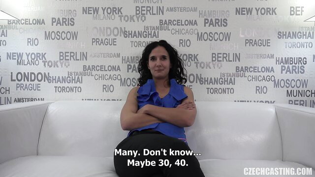 Kinky brunette amateur at casting, maybe 30-40, seated confidently in blue top