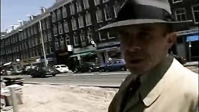 Retro 1940s man in fedora and suit on street, vintage gay porn thumbnail