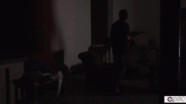 Silhouette of black man standing in dark room, erotic shadow play