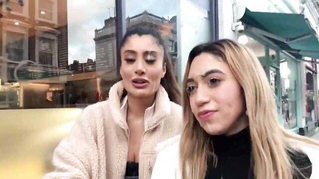 Two busty Middle Eastern women in sexy coats cumwalk on London street