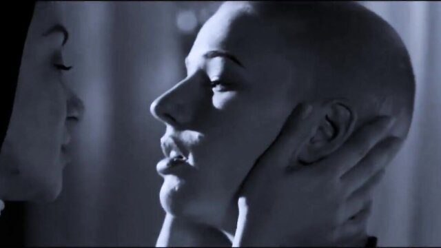 Bald vampire seductress grips neck in intimate close-up from My Vampire Sister