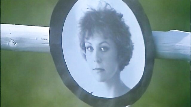 Retro 1976 French porn thumbnail: curly-haired brunette in framed photo on wood post