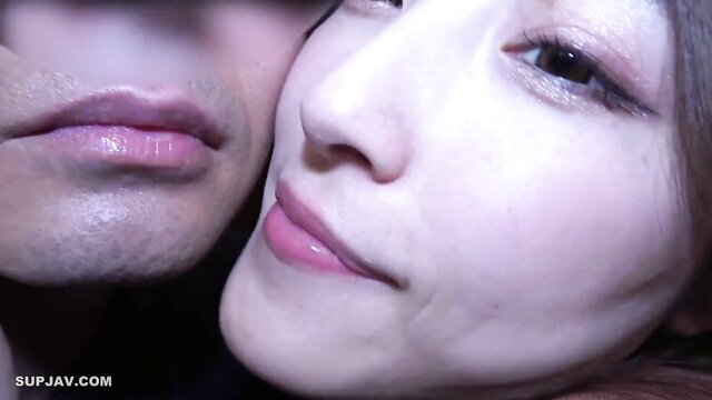 Asian couple close-up kiss, glossy lips, intimate embrace