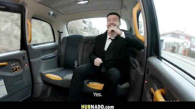 Man in tuxedo sips drink in yellow cab, calm nerves before fast hard action