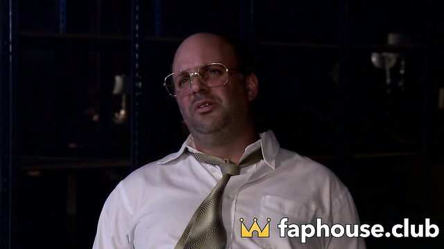 Bald Joker smirks in dimly lit room, FapHouse watermark