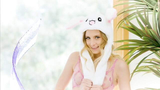 Blonde skinny cutie in bunny hat and lingerie smiles playfully