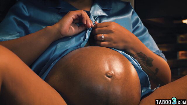 Pregnant ebony MILF Avery Jane in satin robe showing huge belly