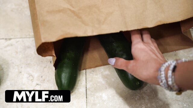 Sexy Mylf stepmom grabs big cucumbers from bag in teasing pose