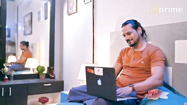 Man with long hair sits on bed with laptop in Hasratey 3