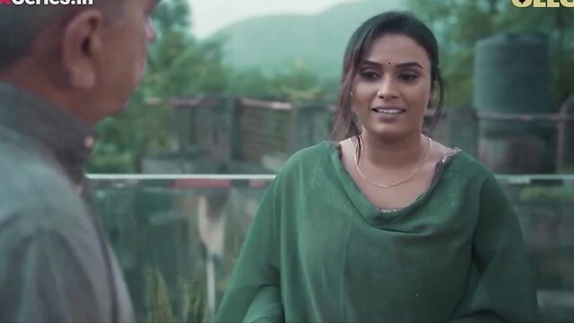 Desi Indian bhabhi in green saree top smiles at man outdoors