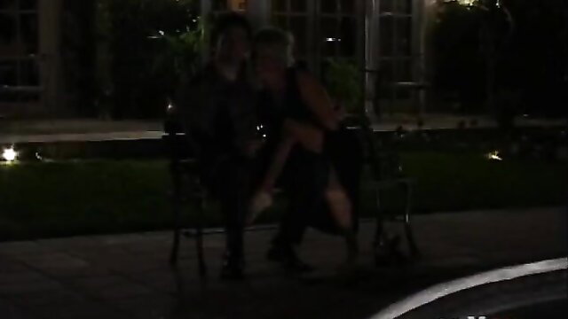 Hot couple in lingerie embracing outdoors at night, teasing seduction