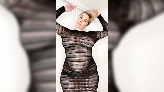 Curvy blonde in sheer striped mesh dress posing seductively