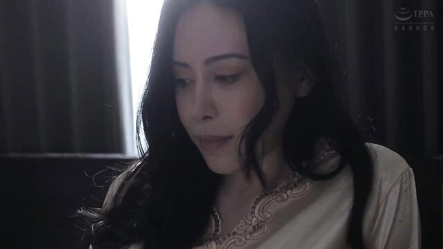 Asian beauty with long black hair in elegant blouse, soft lighting closeup