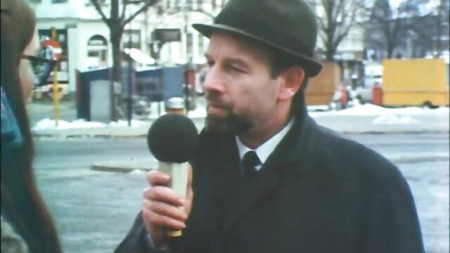 Retro 70s Danish reporter in hat beard mic street interview softcore tease