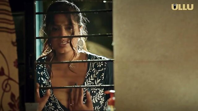 Desi bhabhi with big tits peeking through bars in sexy dress