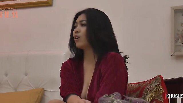 Asian beauty Surti in deep red plunging robe, teasing cleavage closeup