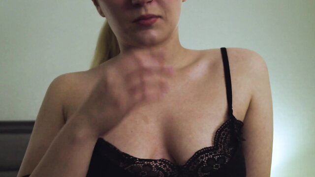 JayBbGirl in black lace lingerie, hand on neck, teasing cleavage