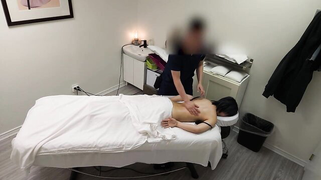 Tiny Japanese girl nude on massage table, masseur groping her ass