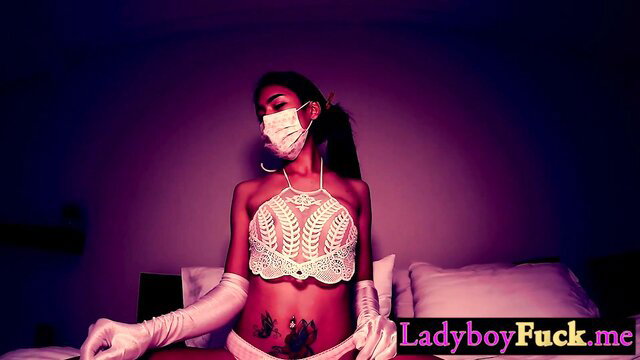 Pepper hot Asian ladyboy in lace lingerie and gloves poses seductively