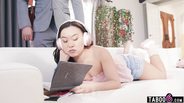 Kimmy Kimm Asian teen in pink headphones and shorts on couch