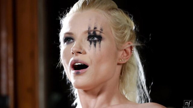 Zazie Skymm blonde fantasy star with bold black face paint, open mouth closeup