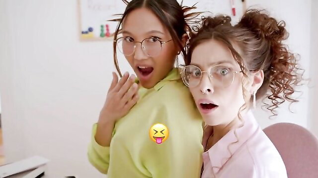 Two shocked Asian babes in glasses and casual clothes react surprised
