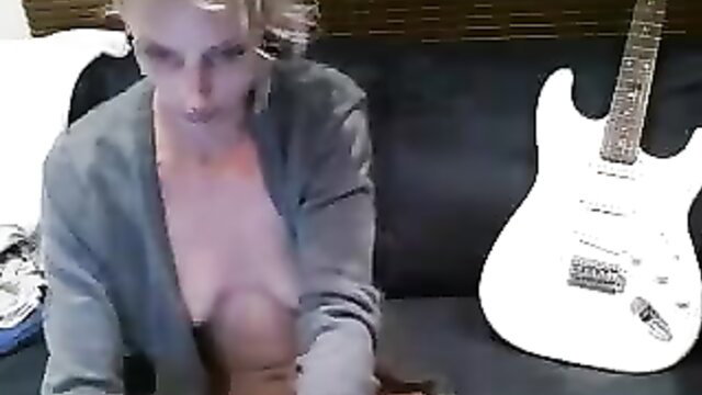 Skinny blonde mom teases tits in open cardigan on couch