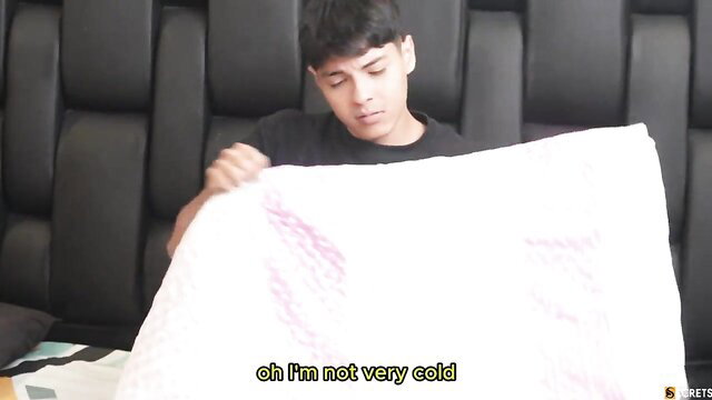 Young Asian guy in black tee holding white sheet with pink stains in bed