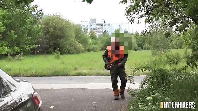 Outdoor amateur guy in orange vest approaches car for random hookup