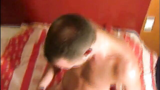 Bald muscular guy kneeling nude on bed in amateur trans sex tape