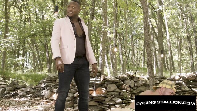 Black suited hunk with white dude in woods gay sex scene