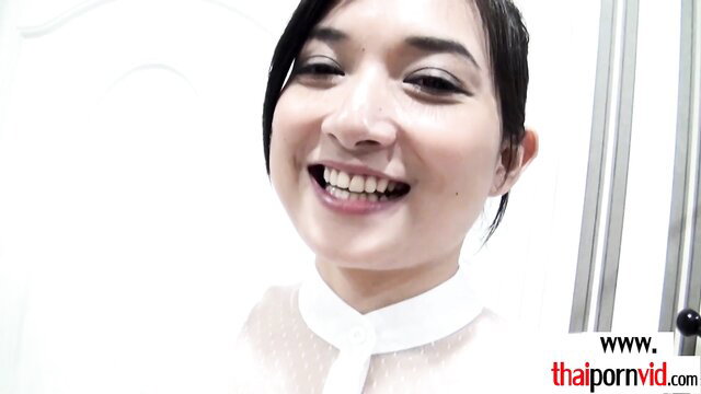 Petite Thai teen Pancake smiling in sheer white blouse, exotic amateur