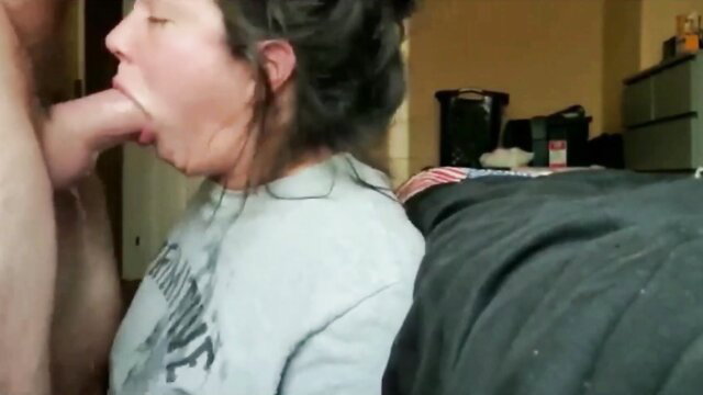 Brunette woman throats thick cock in intense facefuck on bed