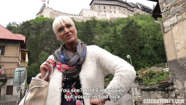 Blonde Czech tour guide in fur coat at Karlstejn Castle