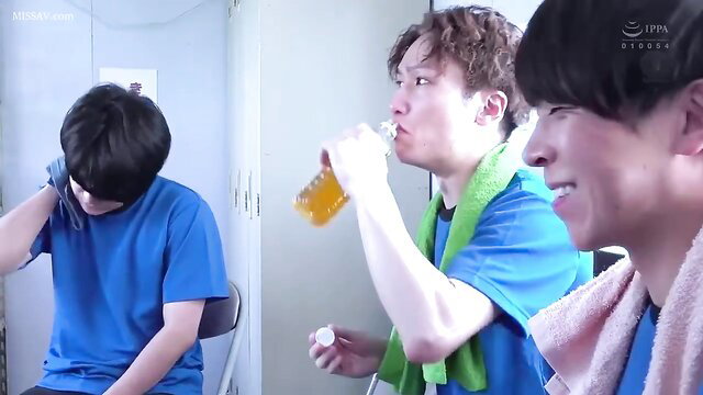 Three fit Japanese guys in locker room, drinking and smiling post-workout