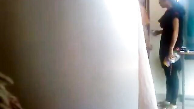 Hot Desi chick in tight jeans and top holding bottle in bedroom