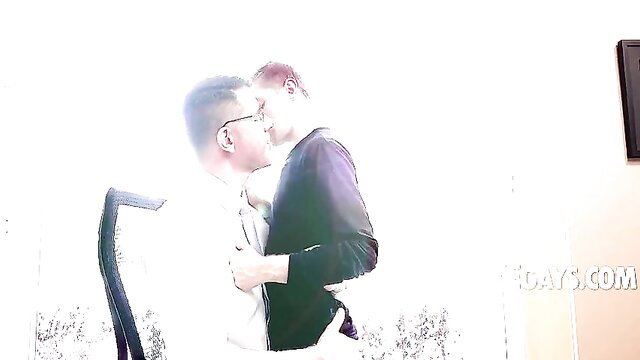 Dr Wolf embraces Tom Bentley in intimate office hug