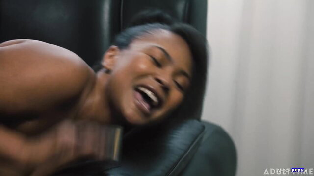 Avery Jane grins in ecstasy as Ryan Keely fingers her on leather chair