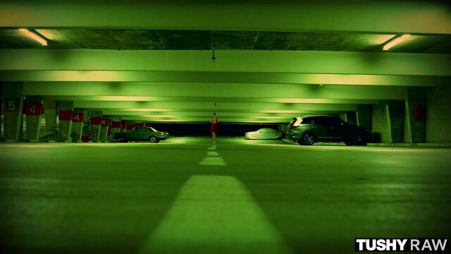 Mazzy Grace in green-lit parking garage, Tushy Raw adult video thumbnail