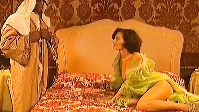 Arab sheikh seduces curvy brunette in sheer green lingerie on bed
