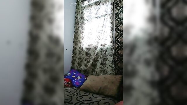 Blurry amateur bedroom scene with sheer curtains and pillows